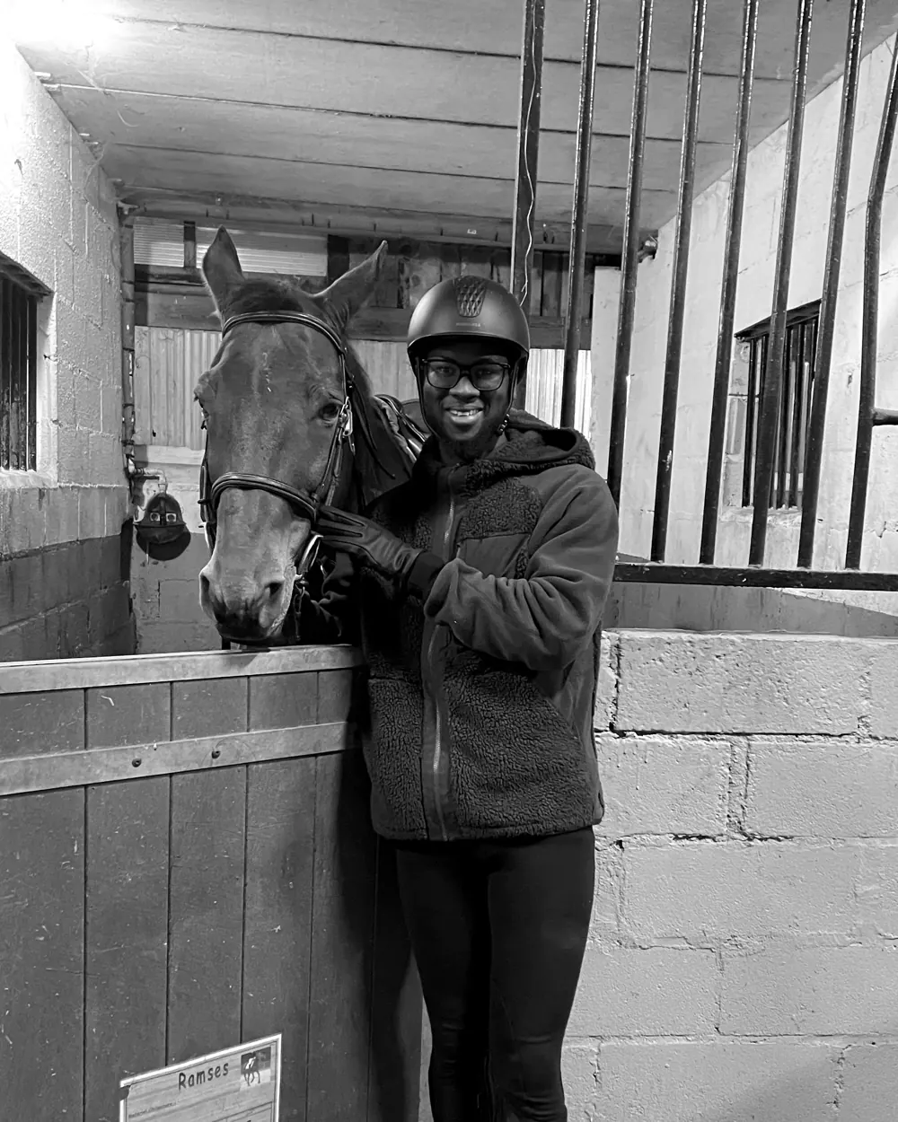 Mbacké with a horse at the stables